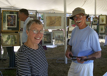 Glenna Richards and Larry Leyman in front of the art auction.