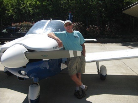 Dwight Guss and his Piper Cherokee 180 at the Port of Orcas.