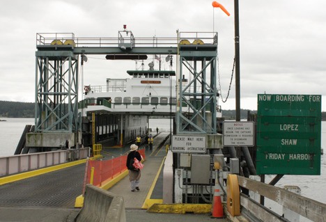 A passenger boards the Evergreen State ferry.