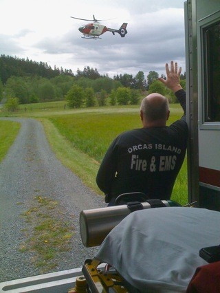 Orcas Paramedic and Division Chief Mik Preysz stands by while AirLift Northwest clears Olga
