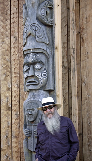 Walter Henderson with the totem pole that he restored.