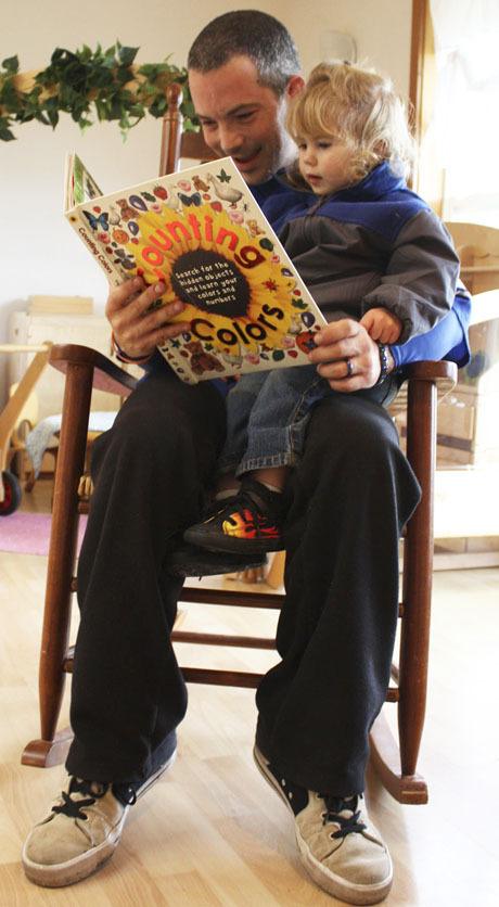 Rob Shaepe reading to his daughter Piper Ann at the Children's House.