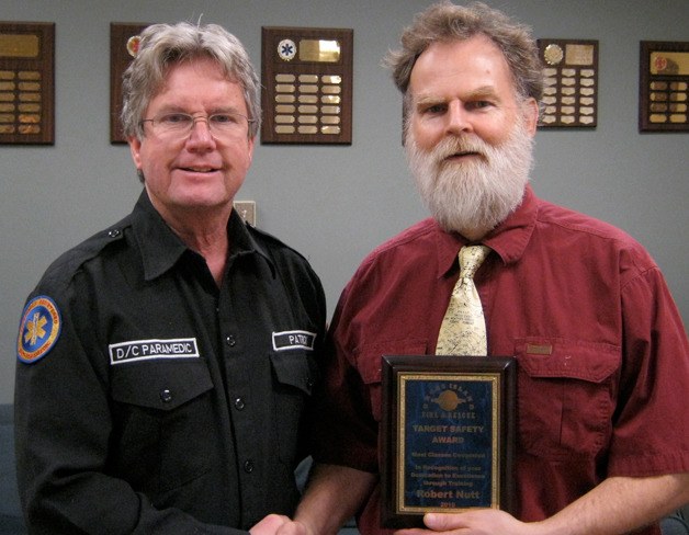 Division Chief Patrick Shepler (left) presents Orcas Island Fire Rescue's first Target Safety Award to Captain Bob Nutt for the most courses completed (44).