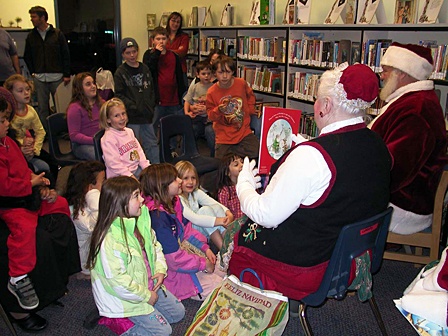 Kids listening to Santa and Mrs. Claus during a previous family reading night.