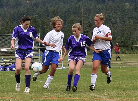 Vikings battle the Wolverines for ball possession. Left to right