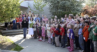 Orcas Elementary students gathered in front of the school's flag on Friday