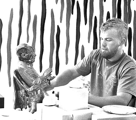 Artist Ryan Lawless putting the finishing touches on a Mao Tze-tung figurine. He is among 14 artists whose talent is being showcased in the “Tons of Art” exhibit at Orcas Center.