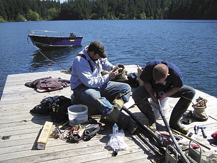Dan Watters and Roger Sandwith repair the faulty cable on the floating dock.