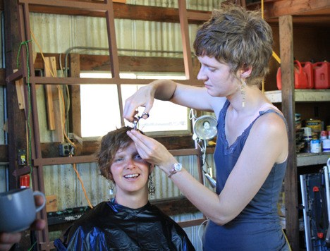 Ali Boe cuts a guest's hair at the event.