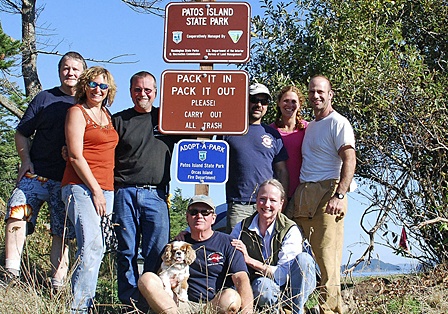 A few members pose with the official Patos Island Sign