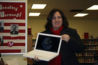 Kindergarten teacher Mandy Randolph showing off one of the elementary school's new computers.