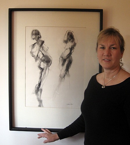 Lori Fast with one of her paintings at the Artworks.