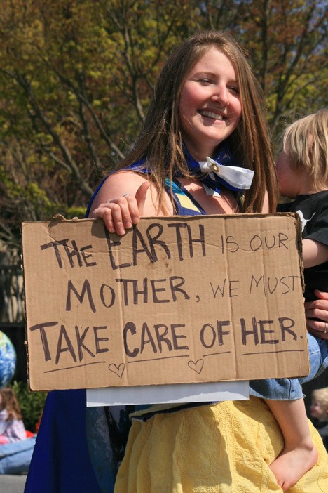 An islander carries a sign in the parade.