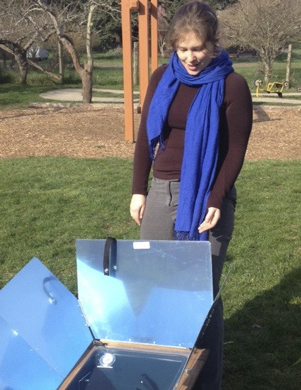Emily Barrett of the Bonneville Environmental Foundation demonstrates the solar oven.