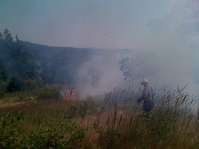 Wildland Firefighter Rich Harvey scouts fire moving towards Westsound.
