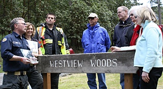 Fire Chief Mike Harris (far left) presenting the Firewise plaque to Westview Woods.