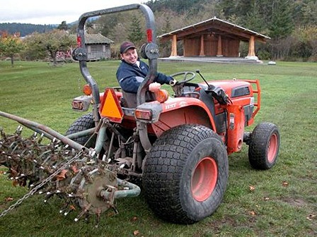 Volunteer Justin Taylor aerating the Village Green.