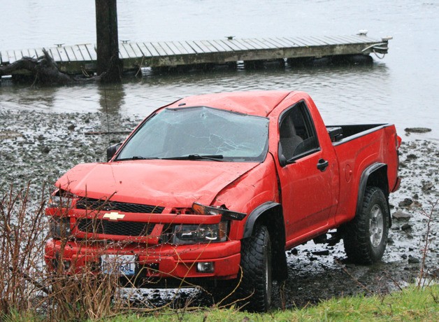 A truck rolled down the embankment from the Channel Road bridge and landed with its wheels on the mud flat.