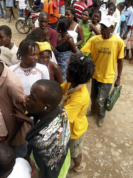 Rosedanie Cadet (foreground) during distribution of soap and bleach in Camp Coq