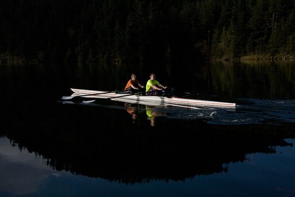 Max Blackadar and Josh Bronn rowing across the mirror-like surface of Cascade Lake. Orcas Island Rowing Club’s fall rowing season begins on Saturday