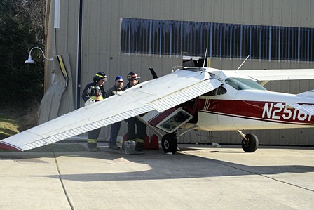 Responders cleaning up a fuel leak from the plane.