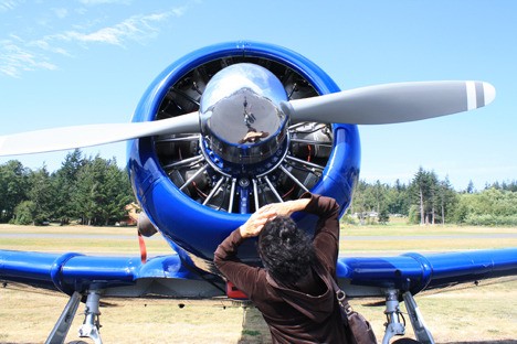 A Fly In guest admires a plane's engine.