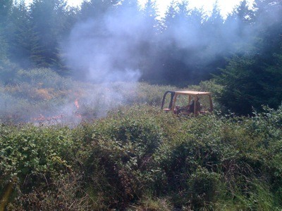 Dozer Operator Bill Hoyt cuts fire line through thick brush to stop fire spread