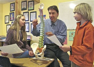 Dr. Jim Litch talks about the human spine with Salmonberry School students Emma Freedman