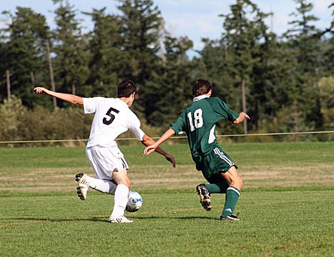 Viking Christopher Ghazel competes for possession  against a Cedar Park Christian player.