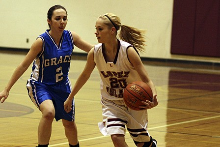 Lobo Sarah Stanley drives the ball down the court during the game against Grace Academy.