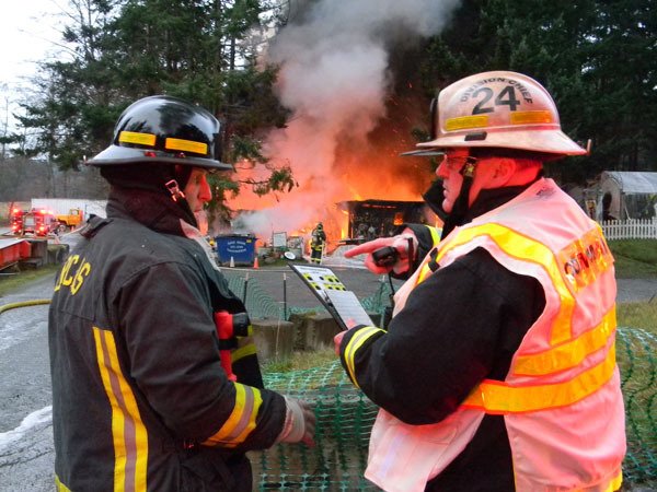 Firefighter Doug Maya (left) and assistant chief Mik Preysz at the fire.