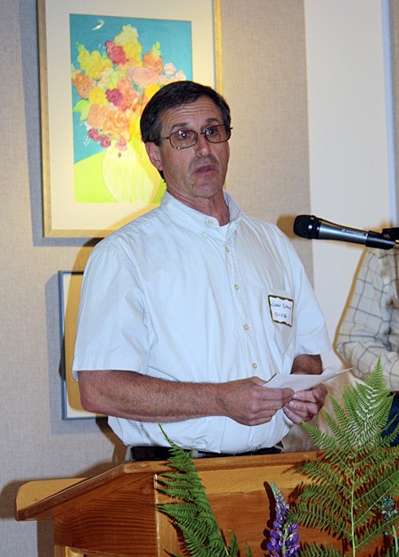 Food Bank president Larry Shaw accepting a $3500 grant for dairy and eggs given to the Food Bank by the Orcas Island Community Foundation on June 3.