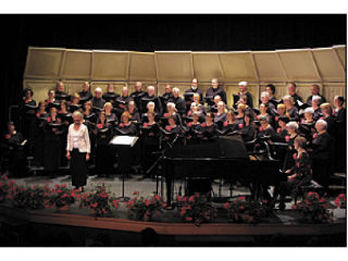 Top: Catherine Pederson and the Orcas Island Choral Society. Chris Thomerson photo.  Below: The members of the Orcas Island Choral Society prepare for the holiday performance. Nina Laramore photos.