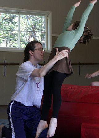 Shelley Russell teaching gymnastics to her students.