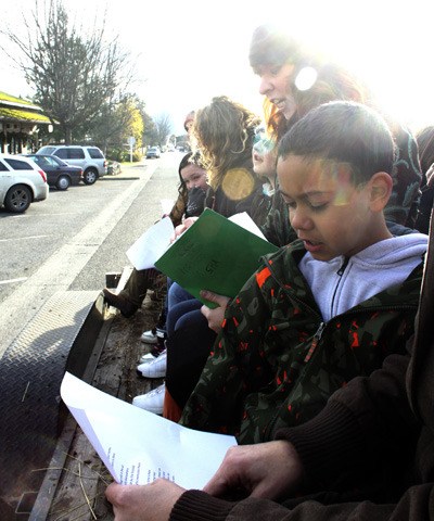 Grace McCune leads island children in singing Christmas carols on the hay ride.