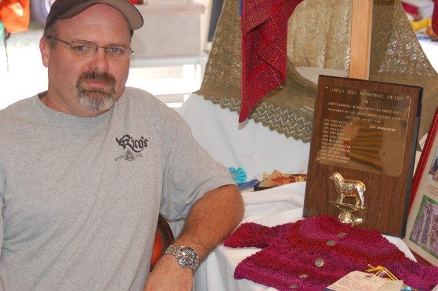 Greg White with his prize-winning baby sweater.