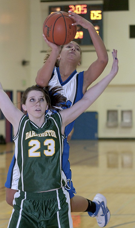 Stephanie Shaw (11) drives to the basket early in a hard fought game.