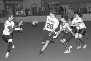 Jordon Griffith receives the ball on an option-run from Jeffery Blankenship while Olivia Roseberry blocks in recent indoor football action.