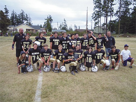 A very happy Kings football team with its Island Cup trophy.