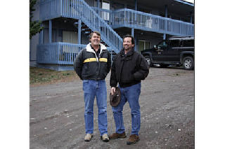 L-R: Wesley Heinmiller and Alan Stameisen in front of the apartments they plan to renovate.