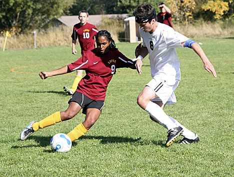 Lopez player #9 works to push the ball past a Viking.