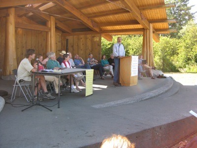 Lance Evans speaks to the public during the EPRC 'Report to the People' on the Village Green on July 2.