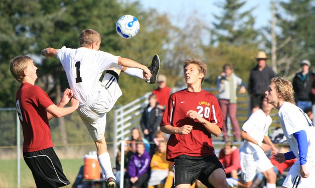 Aidan McCormick leaps to clear the ball during a Lopez attack.