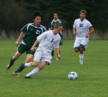 Aidan McCormick steals the ball from a Cedar Park attacker