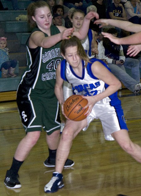 April Hofmann looks for an opening under the basket