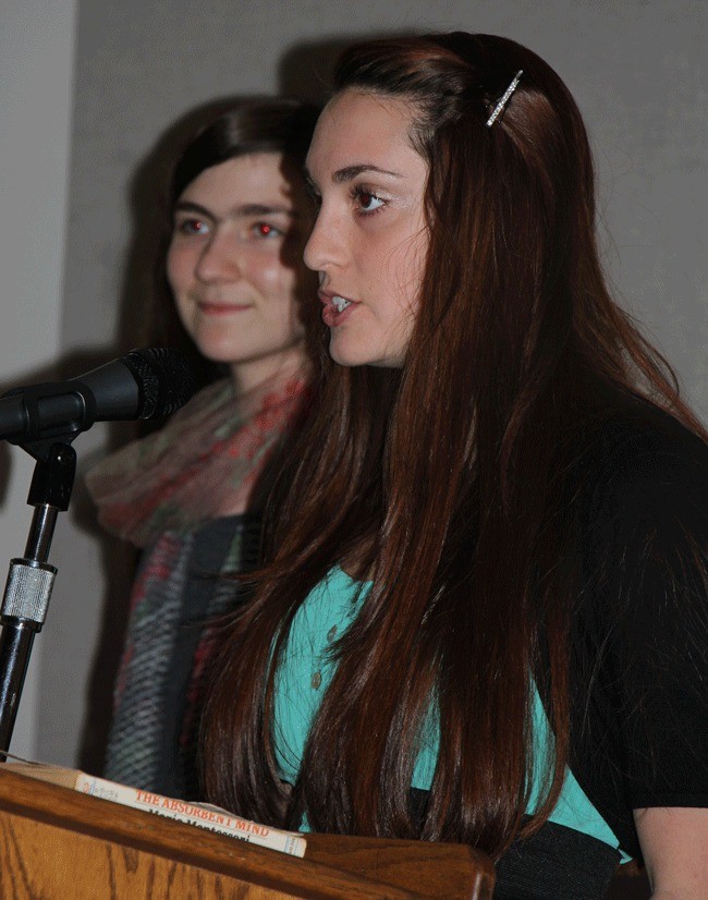 High school seniors Brigid Ehrmantraut (back) and Lindsay Lancaster presenting grant awards at the annual meeting.