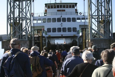 Orcas Islanders board the ferry for the annual OPALCO meeting on May 4.
