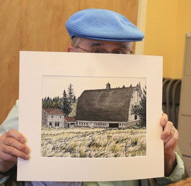 Ray McBride with an original painting. The drawings are part of a calendar for the Orcas Island Historical Museum.