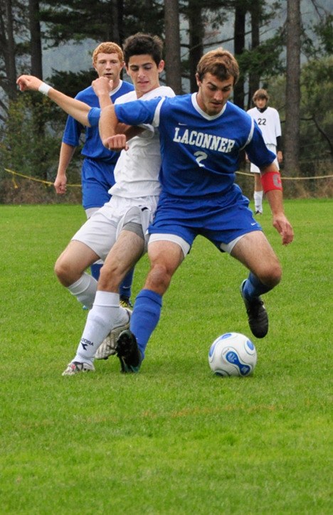 Christopher Ghazel contends with a La Conner player for possession.