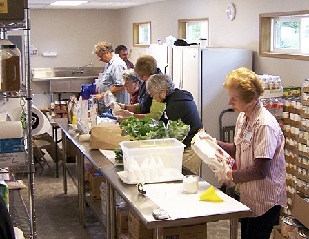 Food Bank volunteers sort and prepare food items for distribution out of their new building recently opened on Madrona Street.